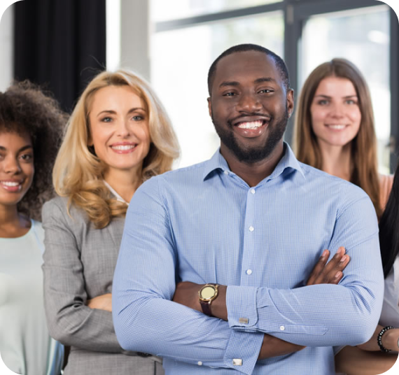 Image of a group of young professionals smiling at the camera.